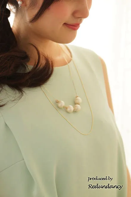 パステルグリーンのノースリーブタックドレス